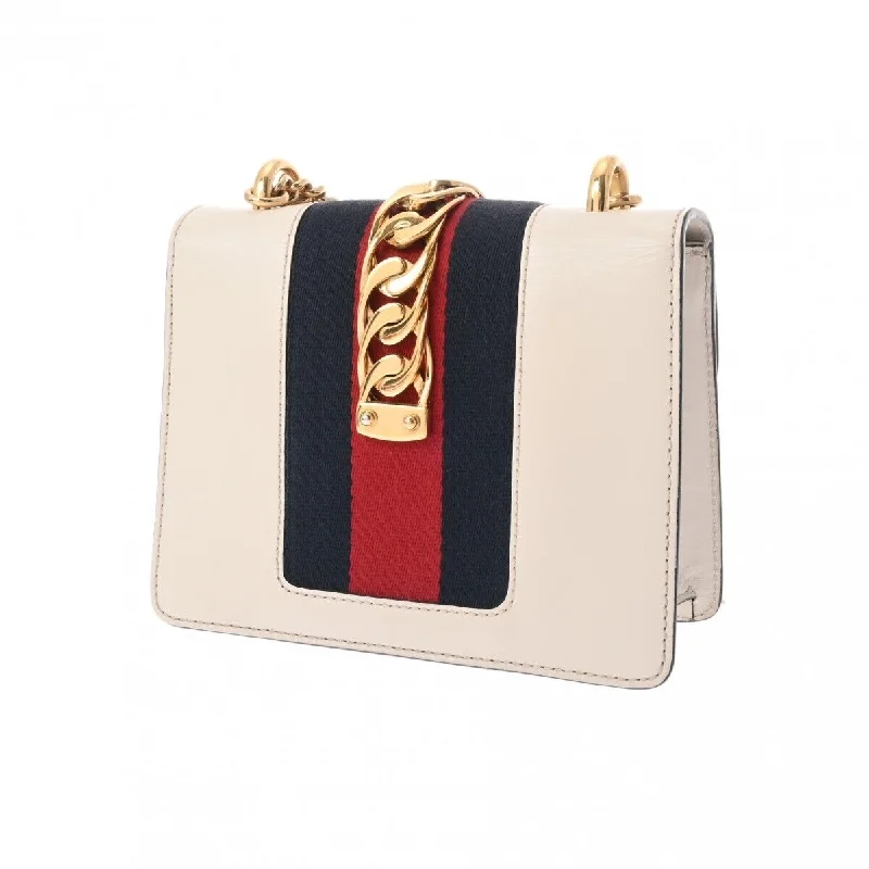 Women Gucci bags with a snap - button closure and a decorative charmWomen Gucci bags with a snap - button closure and a decorative charmGucci Silvi Mini Chain Shoulder Bag